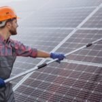 Dust-covered solar panels in desert environment Technician cleaning utility-scale solar farm Graph showing thermal derating impact on solar efficiency Cooling system installed on photovoltaic panels Drone inspection of solar farm in arid region Robotic cleaning technology for solar panels Steelbridge Export logo with solar equipment Solar panels with sand accumulation before cleaning Heat map showing temperature coefficient effect on solar panels Optimized solar panel array in Middle Eastern desert