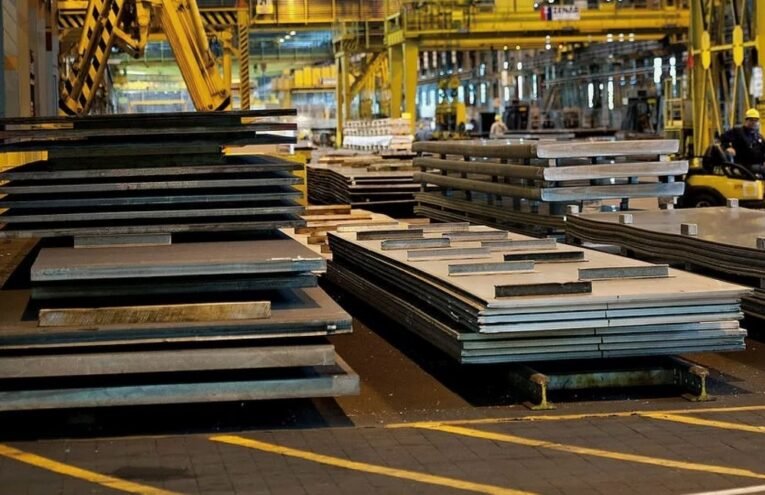 Steelbridge Export international trading team overseeing metal shipment at a global port with stacked containers and steel coils.