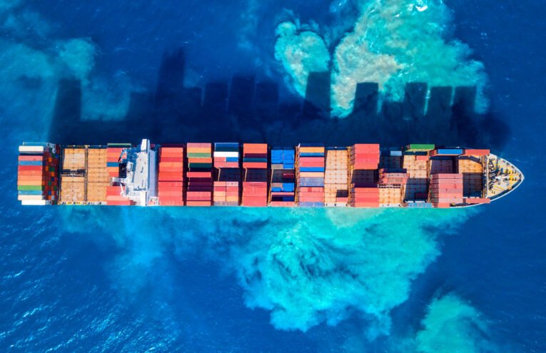 A cargo ship loaded with raw materials arriving at an international port—Steelbridge Export facilitating global trade.
