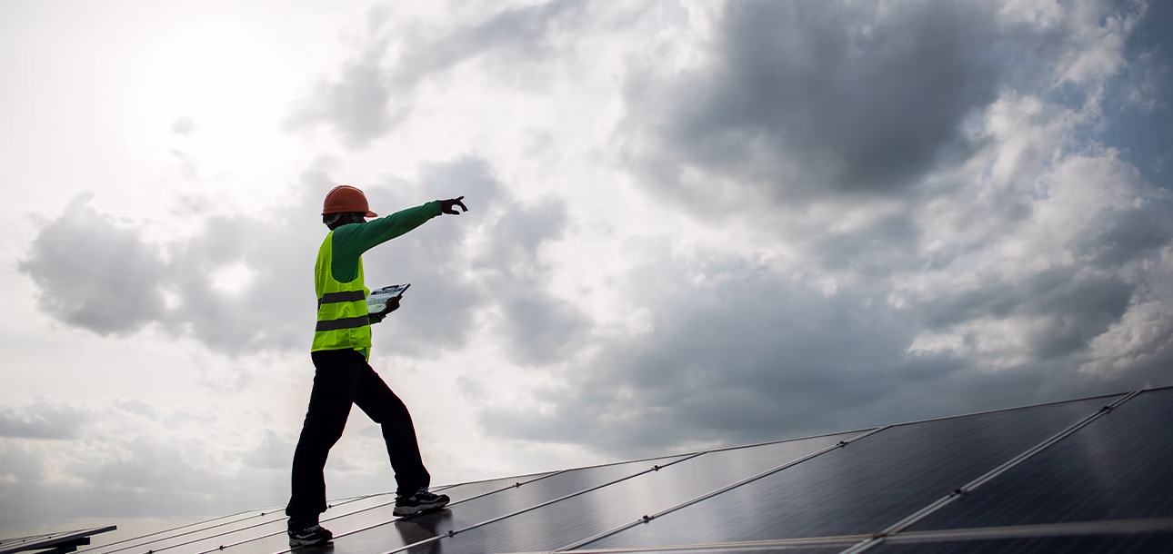 Solar panels and fossil fuel power plants comparison highlighting cost differences in 2025.