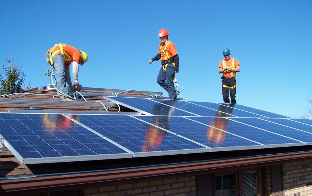 "Solar EPC construction site during the energy transition, with photovoltaic panels being installed for a large-scale infrastructure investment."