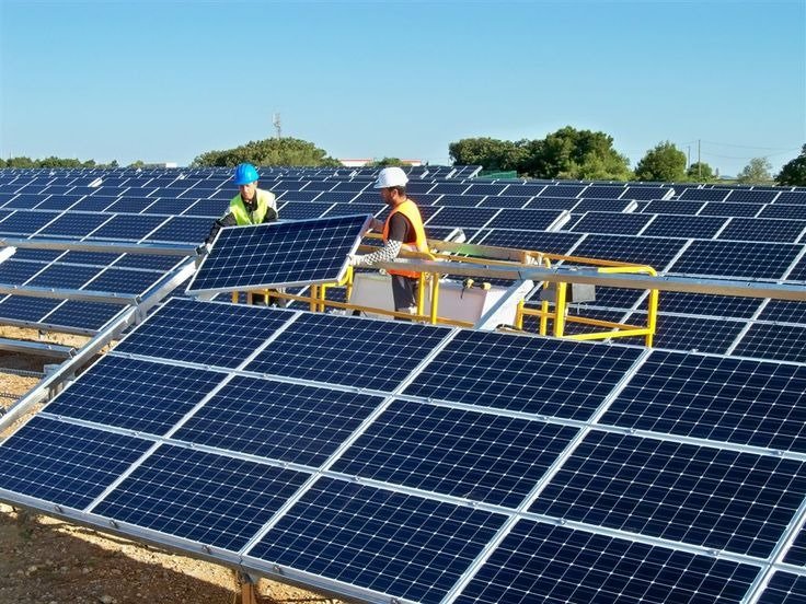 Private equity professionals reviewing investment opportunities in a solar power plant development.