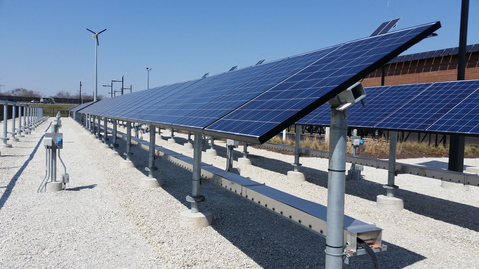 Private equity professionals reviewing investment opportunities in a solar power plant development.