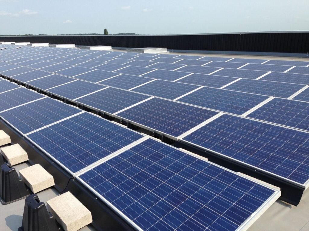 “Technicians inspecting solar panels and batteries at a modern solar power plant — Steelbridge Export, reliable solar equipment supplier.”